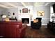 Cozy living room with a white brick fireplace and exposed beams, perfect for relaxing at 408 Greenfern Ct, Burlington, NC 27215