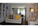 Spacious living room featuring a neutral color palette, hardwood floors and a view into the dining room at 408 Greenfern Ct, Burlington, NC 27215
