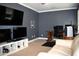 Modern living room with carpet and multiple televisions in media setup at 408 Greenfern Ct, Burlington, NC 27215