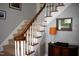 Carpeted staircase featuring a classic wooden handrail and painted white risers at 408 Greenfern Ct, Burlington, NC 27215