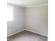 Cozy bedroom with plush carpet, neutral paint, and a large window for natural light at 4112 Forrest Ave, Efland, NC 27243