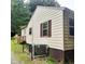 Exterior view of a house showing light siding, brown accents, and outdoor utilities at 4112 Forrest Ave, Efland, NC 27243