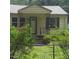 Charming home exterior with welcoming front porch, tidy yard, and classic design elements at 4112 Forrest Ave, Efland, NC 27243