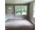 Bright living room featuring a neutral color scheme, cozy carpet, and natural light at 4112 Forrest Ave, Efland, NC 27243