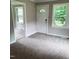 Bright living room featuring a neutral color scheme, cozy carpet, and natural light at 4112 Forrest Ave, Efland, NC 27243