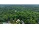 Aerial view of a home surrounded by lush green trees in a private, wooded neighborhood at 4305 Heathgate Ln, Raleigh, NC 27613