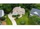Aerial view of home with lush landscaping, long drive, and mature trees at 4305 Heathgate Ln, Raleigh, NC 27613