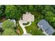 Aerial view of home with lush landscaping and long driveway in a wooded setting at 4305 Heathgate Ln, Raleigh, NC 27613
