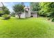 Expansive backyard featuring a well-manicured lawn and a screened-in back porch at 4305 Heathgate Ln, Raleigh, NC 27613