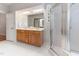 Bathroom featuring double vanity, neutral decor, and glass-enclosed shower at 4305 Heathgate Ln, Raleigh, NC 27613