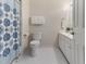 Bathroom with a patterned shower curtain, white toilet, and vanity with sink at 4305 Heathgate Ln, Raleigh, NC 27613