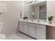 Bathroom featuring a double sink vanity, ample lighting, and a large mirror at 4305 Heathgate Ln, Raleigh, NC 27613