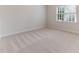 Bedroom with neutral carpet and a window allowing for natural light at 4305 Heathgate Ln, Raleigh, NC 27613