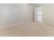 Spacious bedroom with neutral carpet leading to a staircase with railings at 4305 Heathgate Ln, Raleigh, NC 27613