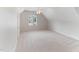 Bright bedroom with a vaulted ceiling, a large window, and neutral carpeting at 4305 Heathgate Ln, Raleigh, NC 27613
