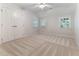 Bedroom featuring three windows and a ceiling fan for added comfort at 4305 Heathgate Ln, Raleigh, NC 27613