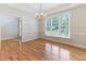 Bright dining room features hardwood floors and a large window for lots of natural light at 4305 Heathgate Ln, Raleigh, NC 27613
