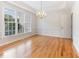 Elegant dining room with hardwood floors, natural light, and a stylish chandelier, perfect for entertaining guests at 4305 Heathgate Ln, Raleigh, NC 27613