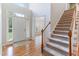Welcoming entryway with hardwood floors, staircase, and large windows providing ample natural light at 4305 Heathgate Ln, Raleigh, NC 27613