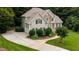 Stunning home showcasing meticulous landscaping and a long, curving driveway at 4305 Heathgate Ln, Raleigh, NC 27613