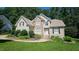 Charming two-story home with stone accents, manicured lawn, and lush landscaping at 4305 Heathgate Ln, Raleigh, NC 27613