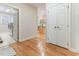 Hallway leading to the laundry room and kitchen with hardwood floors at 4305 Heathgate Ln, Raleigh, NC 27613
