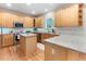 Well-appointed kitchen with wooden cabinets, granite countertops, stainless steel appliances, and a kitchen island at 4305 Heathgate Ln, Raleigh, NC 27613