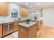 Gourmet kitchen with stainless steel appliances, custom cabinetry, granite countertops, and center island at 4305 Heathgate Ln, Raleigh, NC 27613