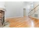 Large living area with fireplace, hardwood floors, staircase, and soaring ceilings at 4305 Heathgate Ln, Raleigh, NC 27613