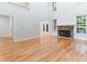 Spacious living room with a fireplace, hardwood floors, and lots of natural light from the windows at 4305 Heathgate Ln, Raleigh, NC 27613