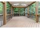Expansive screened porch with a wood floor, railings, and a ceiling fan at 4305 Heathgate Ln, Raleigh, NC 27613