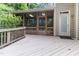 Covered back porch featuring wooden flooring and access door to the exterior at 4305 Heathgate Ln, Raleigh, NC 27613