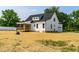 Backyard exterior view of this charming two-story white home with a screened in porch and garage at 4924 Zebulon Rd, Zebulon, NC 27597