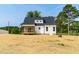 Exterior backyard view of this charming home with a screened in porch and garage at 4924 Zebulon Rd, Zebulon, NC 27597