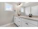 Bathroom with double sink vanity, granite countertops, and framed mirror at 4924 Zebulon Rd, Zebulon, NC 27597
