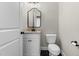 Stylish bathroom with a granite countertop vanity, black fixtures, and designer mirror at 4924 Zebulon Rd, Zebulon, NC 27597