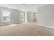 Bright bedroom features carpet floors and plenty of natural light from the three windows at 4924 Zebulon Rd, Zebulon, NC 27597