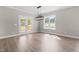 A neutral dining room with wood flooring, a double glass door to outside, and a modern light fixture at 4924 Zebulon Rd, Zebulon, NC 27597