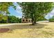 Lovely home with a large yard featuring mature trees and a beautiful lawn, perfect for outdoor enjoyment at 4924 Zebulon Rd, Zebulon, NC 27597