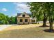 Charming two-story home featuring brick and siding, complemented by a well-manicured lawn and mature trees at 4924 Zebulon Rd, Zebulon, NC 27597
