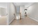 Bright hallway features carpet flooring, staircase, and access to multiple rooms at 4924 Zebulon Rd, Zebulon, NC 27597