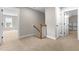 Hallway features carpet flooring, staircase, and access to other rooms of the home at 4924 Zebulon Rd, Zebulon, NC 27597