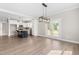 Bright, open kitchen featuring a black island, stainless appliances, and light wood flooring at 4924 Zebulon Rd, Zebulon, NC 27597
