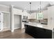 White kitchen with stainless steel appliances and a dark island featuring a marble countertop at 4924 Zebulon Rd, Zebulon, NC 27597