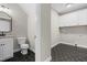 Well-lit laundry room featuring hexagon tile floors, washer/dryer hookups, and storage cabinets at 4924 Zebulon Rd, Zebulon, NC 27597