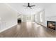 Spacious living room featuring wood flooring, a modern fireplace, and large windows for plenty of natural light at 4924 Zebulon Rd, Zebulon, NC 27597