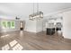 A spacious living room with hardwood floors, a kitchen island, and a staircase to the left at 4924 Zebulon Rd, Zebulon, NC 27597