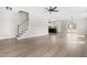 Bright living room with wood flooring, a modern ceiling fan, and an open layout leading to the kitchen at 4924 Zebulon Rd, Zebulon, NC 27597