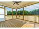 A spacious screened in porch with wood floors and a beautiful view of the wooded backyard at 4924 Zebulon Rd, Zebulon, NC 27597