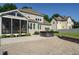 Spacious backyard with patio, hot tub, screened porch, and manicured landscaping at 5305 Yorkville Ct, Holly Springs, NC 27540